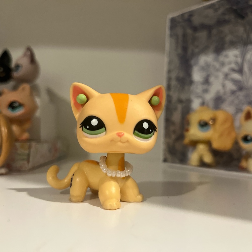 Orange and Cream Cat Figurine with Necklace.